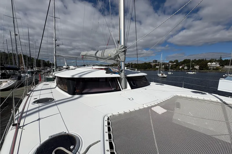 Littlest Hobo Yacht Photos Pics 2009 Fountaine Pajot Orana 44 Maestro catamaran docked, with clear skies and surrounding boats.