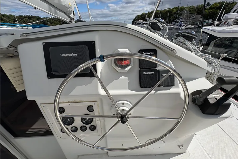 Littlest Hobo Yacht Photos Pics Steering wheel and controls of 2009 Fountaine Pajot Orana 44 Maestro catamaran.