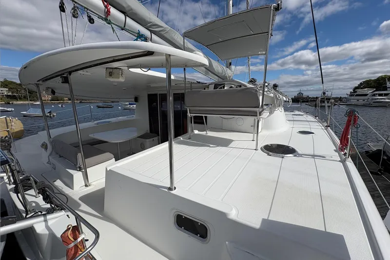 Littlest Hobo Yacht Photos Pics 2009 Fountaine Pajot Orana 44 Maestro catamaran docked, featuring spacious deck and seating area.