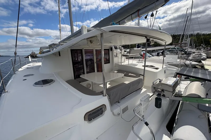 Littlest Hobo Yacht Photos Pics 2009 Fountaine Pajot Orana 44 Maestro catamaran docked, featuring spacious deck and seating area.