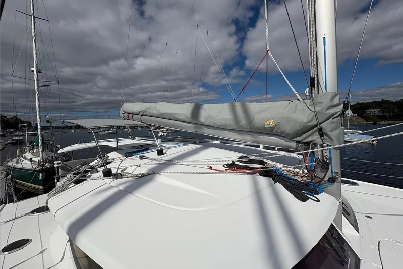 Littlest Hobo Yacht Photos Pics 2009 Fountaine Pajot Orana 44 Maestro catamaran docked, featuring covered sail and clear skies.