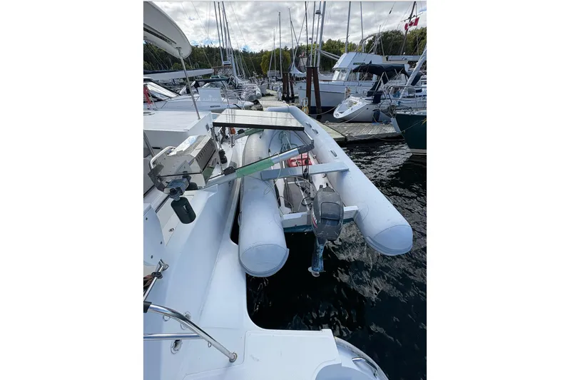 Littlest Hobo Yacht Photos Pics 2009 Fountaine Pajot Orana 44 Maestro catamaran with dinghy at marina.