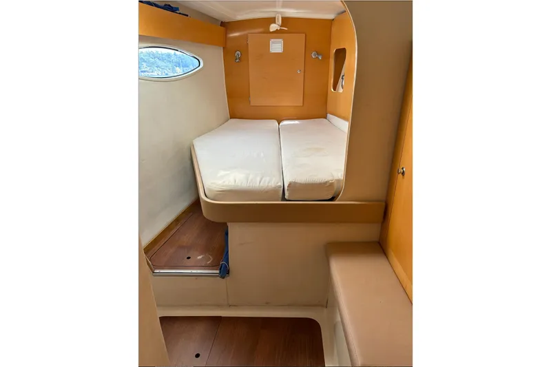 Littlest Hobo Yacht Photos Pics Interior cabin of 2009 Fountaine Pajot Orana 44 Maestro, featuring a cozy bed and wooden flooring.