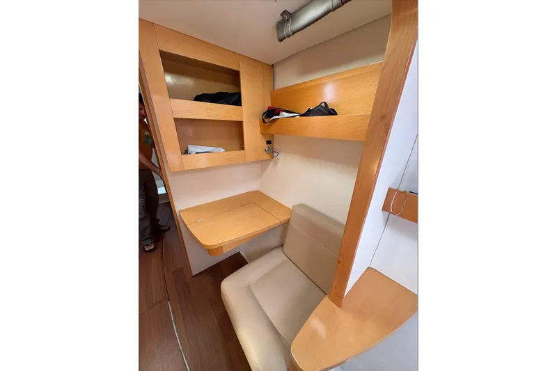 Littlest Hobo Yacht Photos Pics Interior of 2009 Fountaine Pajot Orana 44 Maestro, featuring wooden shelves and a compact desk.