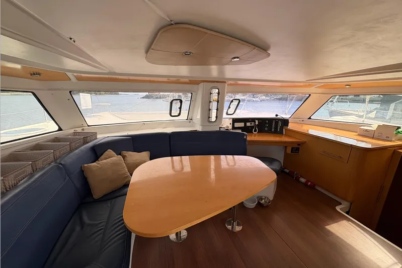 Littlest Hobo Yacht Photos Pics Interior of 2009 Fountaine Pajot Orana 44 Maestro, featuring a cozy seating area and navigation station.