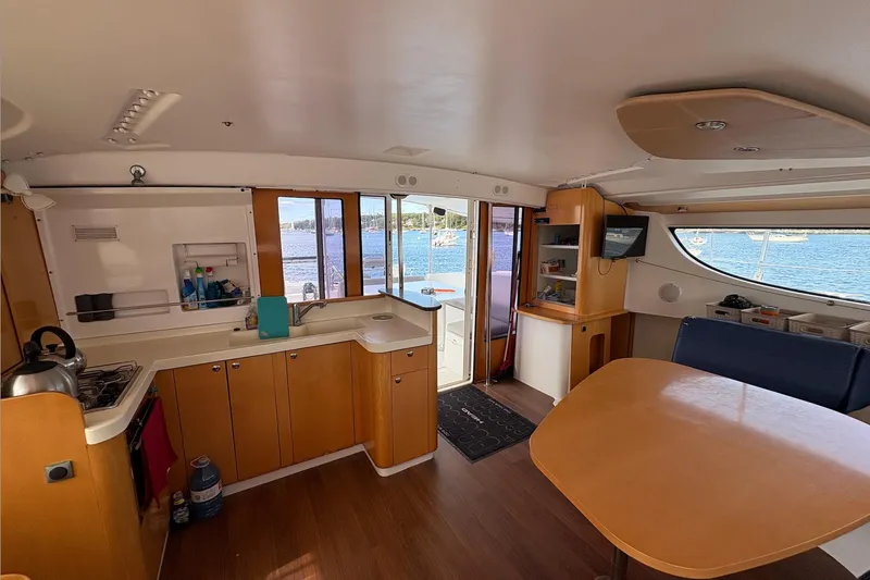 Littlest Hobo Yacht Photos Pics Interior of 2009 Fountaine Pajot Orana 44 Maestro catamaran with kitchen and dining area.