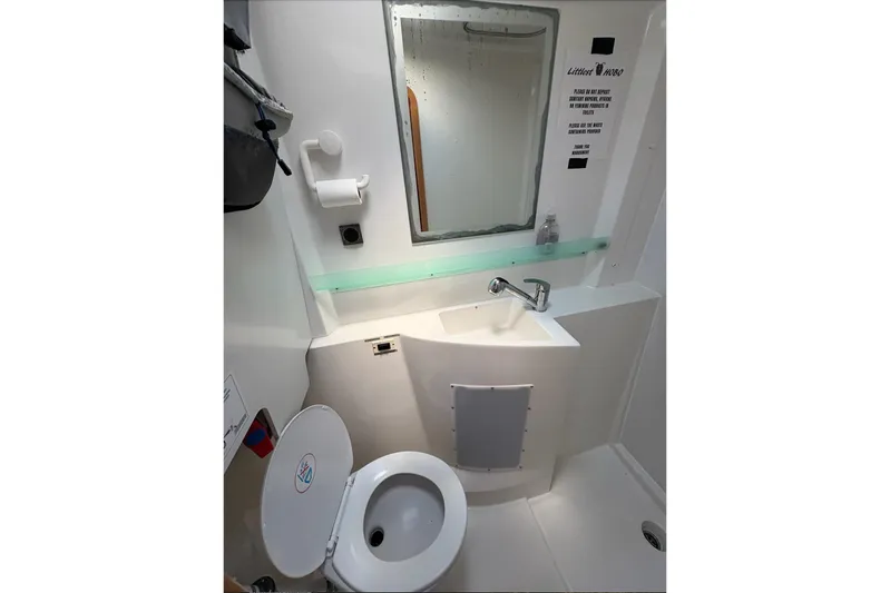Littlest Hobo Yacht Photos Pics Bathroom interior of 2009 Fountaine Pajot Orana 44 Maestro catamaran, featuring sink and toilet.