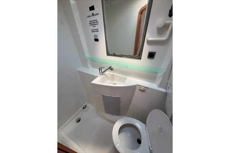Littlest Hobo Yacht Photos Pics Bathroom interior of 2009 Fountaine Pajot Orana 44 Maestro catamaran, featuring sink and toilet.