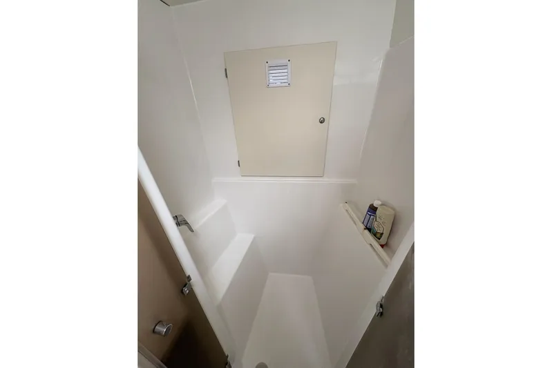 Littlest Hobo Yacht Photos Pics Shower area in 2009 Fountaine Pajot Orana 44 Maestro catamaran, featuring storage shelf.