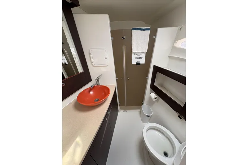 Littlest Hobo Yacht Photos Pics Bathroom interior of 2009 Fountaine Pajot Orana 44 Maestro, featuring modern sink and toilet.