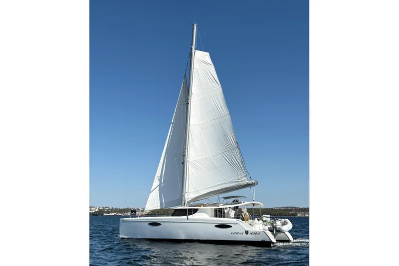 Littlest Hobo Yacht Photos Pics 2009 Fountaine Pajot Orana 44 Maestro sailing on open water under clear blue skies.