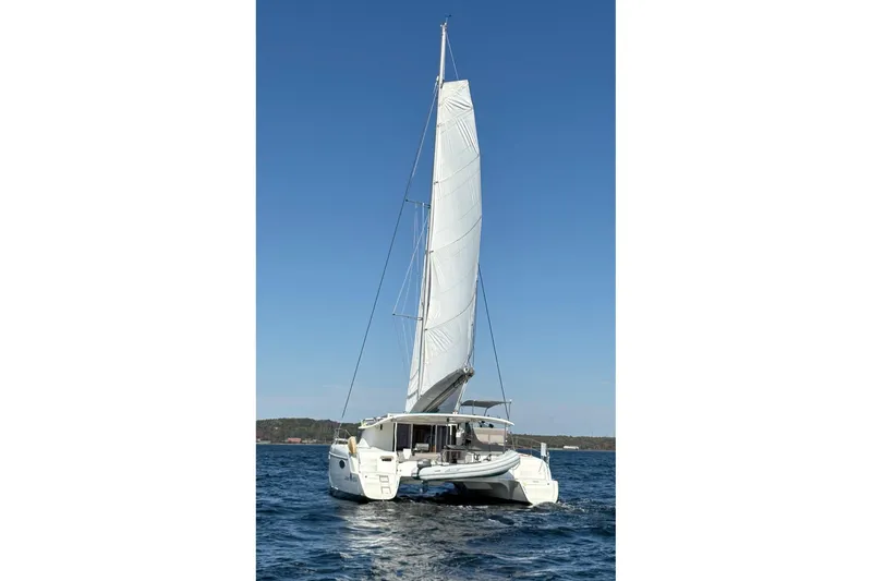 Littlest Hobo Yacht Photos Pics 2009 Fountaine Pajot Orana 44 Maestro sailing on open water under clear blue sky.