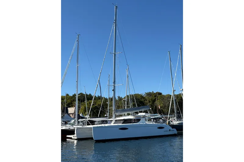 Littlest Hobo Yacht Photos Pics 2009 Fountaine Pajot Orana 44 Maestro catamaran docked in a marina under clear blue sky.