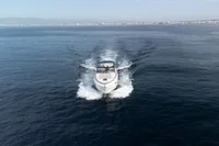 2016 Princess V48 Open yacht cruising on open water, distant coastline visible.