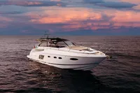 2016 Princess V48 Open yacht on calm sea at sunset.