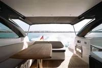 2016 Princess V48 Open yacht interior with table, seating, and ocean view.