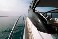 2016 Princess V48 Open yacht cruising on calm waters, showcasing sleek design and luxury.
