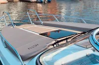 2016 Quicksilver Activ 805 Sundeck boat on water, featuring sleek design and spacious deck.