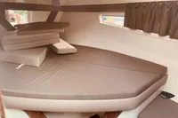 2016 Quicksilver Activ 805 Sundeck cabin interior with beige cushions and window curtains.