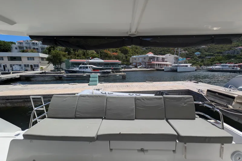 Love A Fayre Yacht Photos Pics Fountaine Pajot Astrea 42 yacht docked at marina, featuring comfortable outdoor seating.