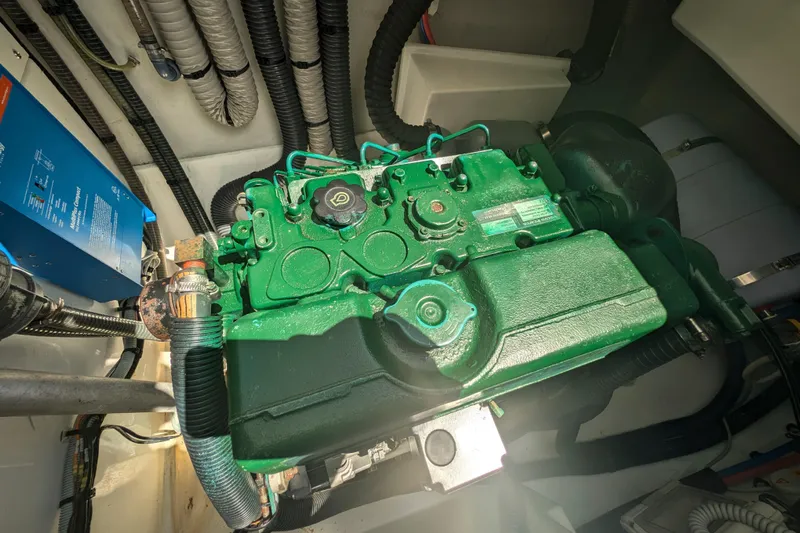 Love A Fayre Yacht Photos Pics Engine compartment of 2020 Fountaine Pajot Astrea 42 catamaran, showcasing green engine and wiring.
