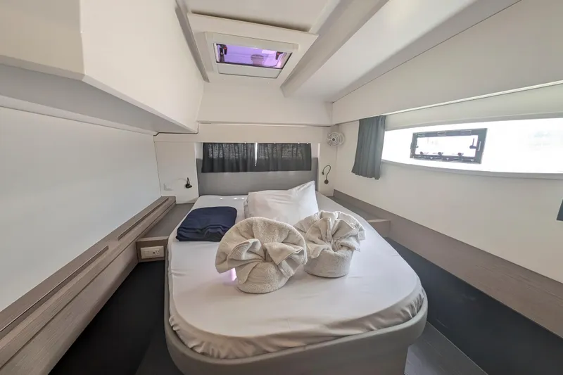 Love A Fayre Yacht Photos Pics Luxurious cabin interior of 2020 Fountaine Pajot Astrea 42 catamaran with neatly arranged bed.