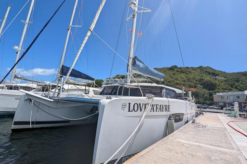 Love A Fayre Yacht Photos Pics 2020 Fountaine Pajot Astrea 42 catamaran docked at marina under clear blue sky.