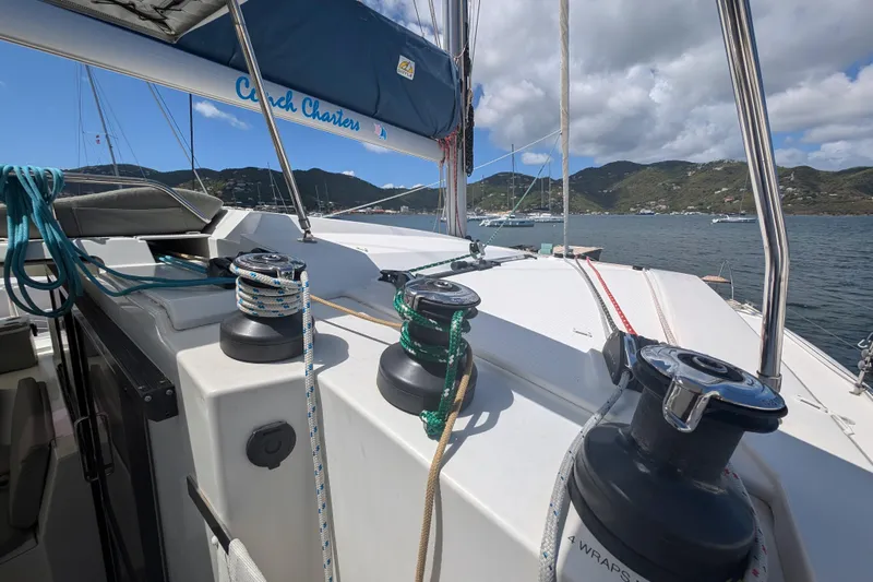 Love A Fayre Yacht Photos Pics Fountaine Pajot Astrea 42 sailboat deck with winches, ropes, and scenic ocean view, 2020 model.