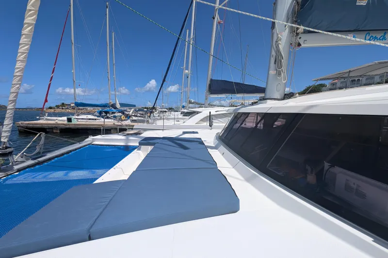 Love A Fayre Yacht Photos Pics 2020 Fountaine Pajot Astrea 42 catamaran docked, featuring spacious deck and blue sky.