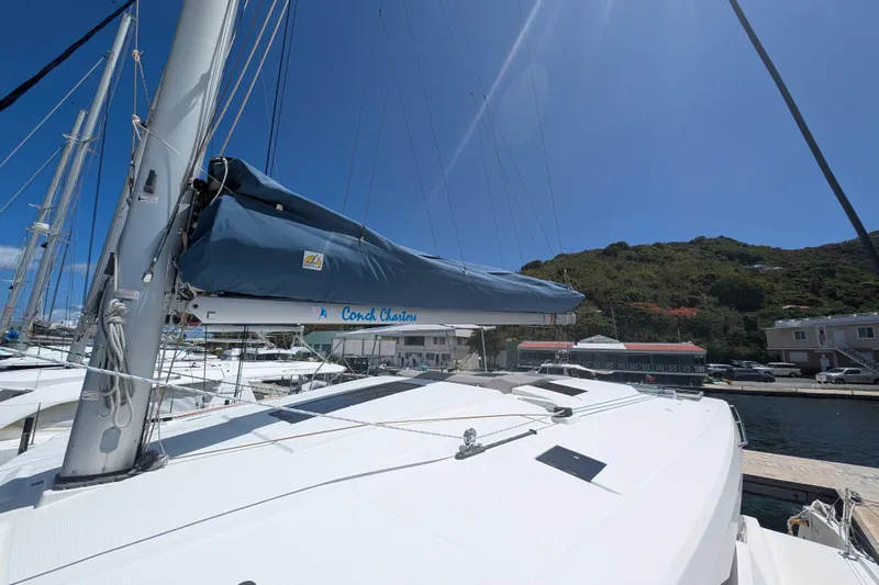 Love A Fayre Yacht Photos Pics 2020 Fountaine Pajot Astrea 42 catamaran docked at marina under clear blue sky.