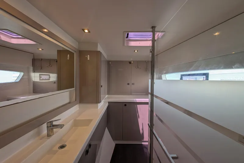 Love A Fayre Yacht Photos Pics Modern bathroom interior of 2020 Fountaine Pajot Astrea 42 catamaran, featuring sleek design and ample lighting.