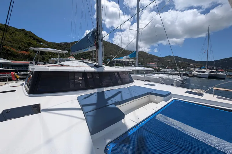 Love A Fayre Yacht Photos Pics 2020 Fountaine Pajot Astrea 42 catamaran docked in a scenic marina.