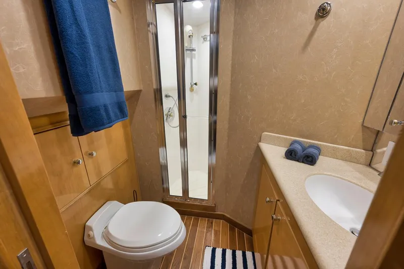 Copper Yacht Photos Pics Bathroom interior of 2002 Hatteras 75 Cockpit Motor Yacht with shower and sink.