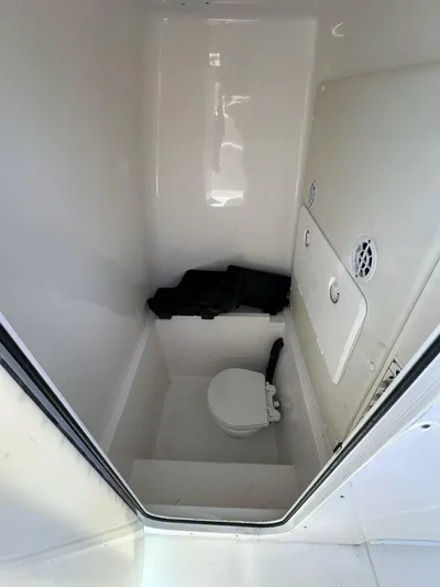  Yacht Photos Pics 2013 Contender 28 Tournament boat interior with toilet and storage compartment.