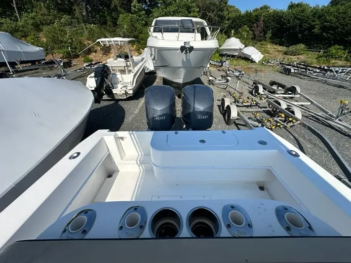  Yacht Photos Pics 2013 Contender 28 Tournament boat with twin 300 HP engines in a storage yard.