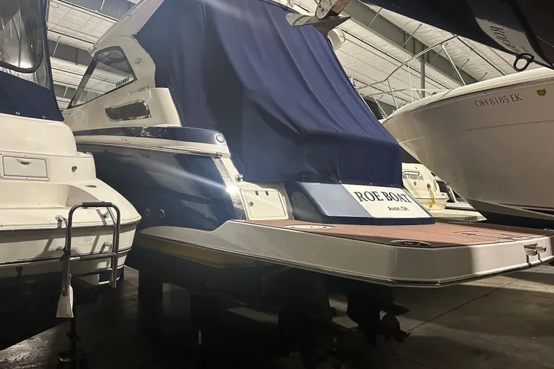 Roe Boat Yacht Photos Pics 2014 Regal 35 Sport Coupe in storage, covered, with adjacent boats.