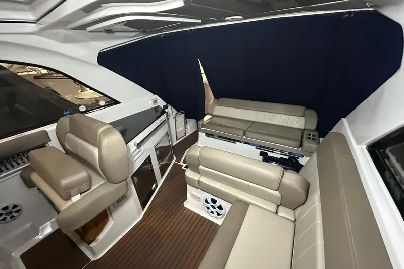 Roe Boat Yacht Photos Pics Interior of 2014 Regal 35 Sport Coupe with beige seating and wood flooring.