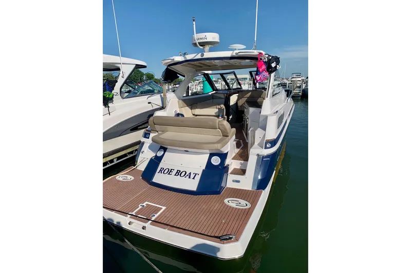 Roe Boat Yacht Photos Pics 2014 Regal 35 Sport Coupe boat docked, featuring spacious seating and modern design.