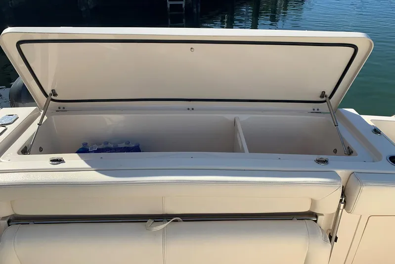  Yacht Photos Pics Open storage compartment on 2015 Grady-White Express 370 boat, docked by water.