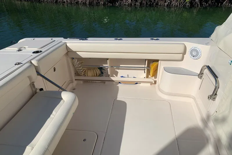  Yacht Photos Pics 2015 Grady-White Express 370 boat interior, featuring seating and storage, near water.