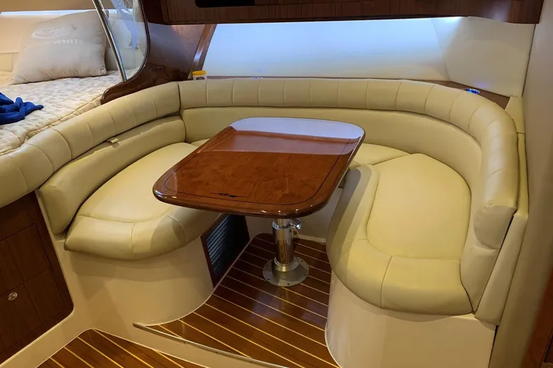  Yacht Photos Pics Luxurious interior of 2015 Grady-White Express 370 with elegant seating and wooden table.