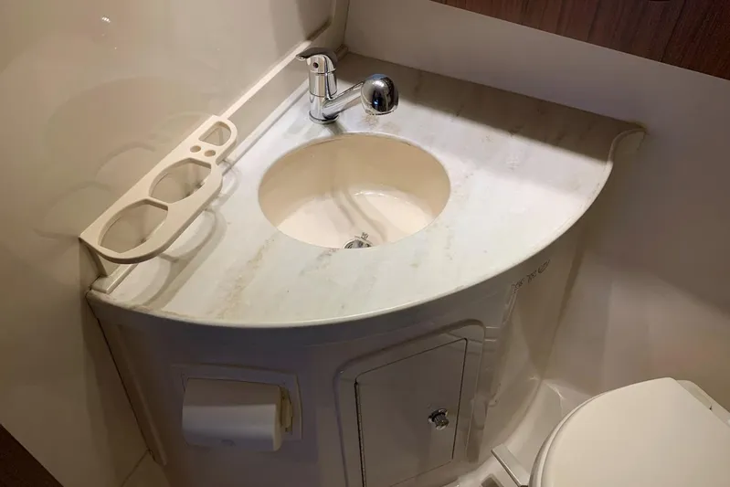  Yacht Photos Pics Bathroom sink area in 2015 Grady-White Express 370 boat, featuring a compact design.