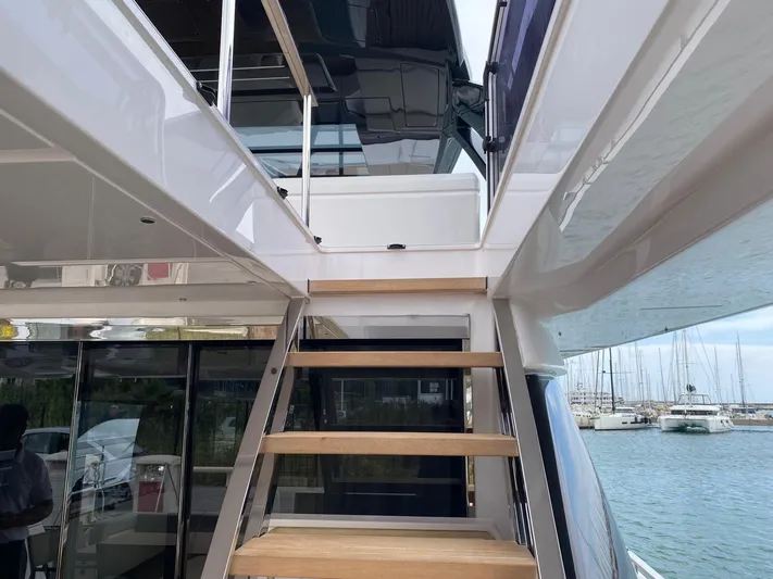 Kayra 1 Yacht Photos Pics 2024 Ferretti Yachts 780, elegant staircase leading to upper deck, marina view.
