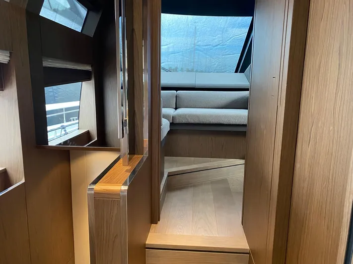 Kayra 1 Yacht Photos Pics Interior view of 2024 Ferretti Yachts 780, featuring modern wood finishes and seating area.