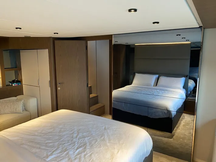 Kayra 1 Yacht Photos Pics Luxurious bedroom interior of 2024 Ferretti Yachts 780 with modern design and cozy bedding.