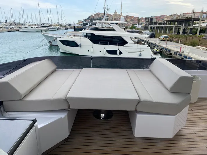 Kayra 1 Yacht Photos Pics Luxurious 2024 Ferretti Yachts 780 with spacious deck seating in a marina setting.