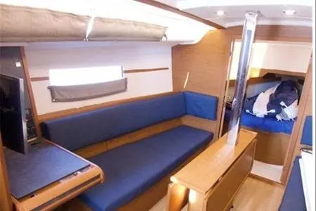 Yacht Photos Pics 2023 Jeanneau Sun Odyssey 349 Performance interior with blue seating and wooden finishes.