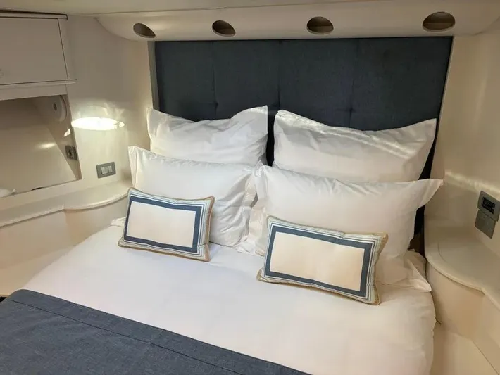  Yacht Photos Pics Luxurious bedroom interior on 2005 Baia Atlantica 78 yacht with plush pillows and elegant decor.