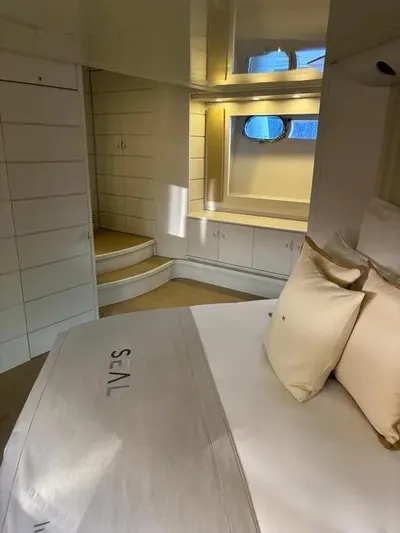  Yacht Photos Pics Luxurious cabin interior of a 2005 Baia Atlantica 78 yacht with elegant bedding and porthole.