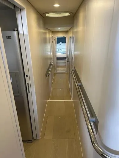  Yacht Photos Pics Narrow hallway inside 2005 Baia Atlantica 78 yacht, featuring sleek design and modern finishes.